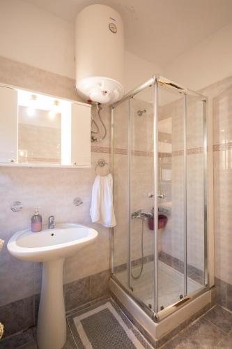 a bathroom with a shower and a sink at Andrew's Old Town Apartment in Corfu