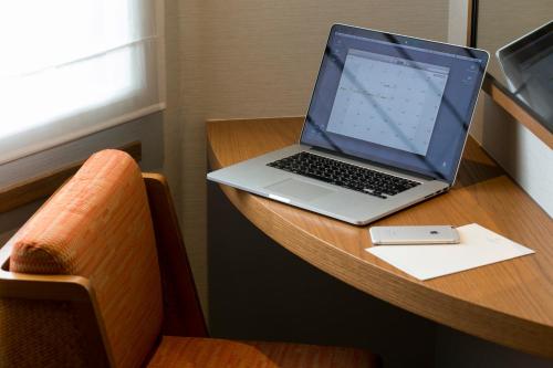 a laptop computer sitting on top of a wooden desk at Highland Resort Hotel & Spa in Fujiyoshida