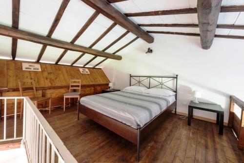 a bedroom with a bed and a wooden floor at Il Castoro di Martignano in Anguillara Sabazia