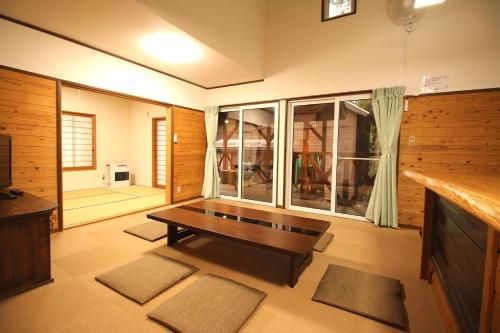 a living room with a table and a large window at Cottage All Resort Service / Vacation STAY 8444 in Inawashiro