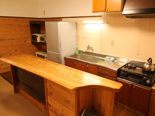 a kitchen with a sink and a refrigerator at Cottage All Resort Service / Vacation STAY 8444 in Inawashiro