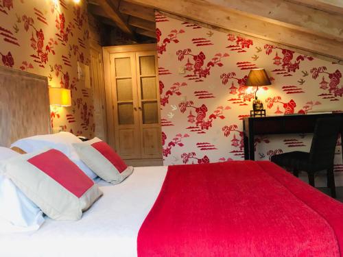 a bedroom with a large bed with a red blanket at Narbasu Restaurante y Hotel in Cereceda