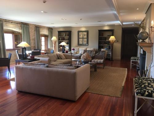 a living room with a couch and a table at Narbasu Restaurante y Hotel in Cereceda