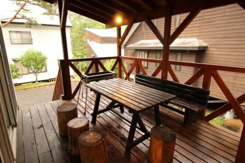 a wooden bench sitting on a wooden deck at Cottage All Resort Service / Vacation STAY 8444 in Inawashiro