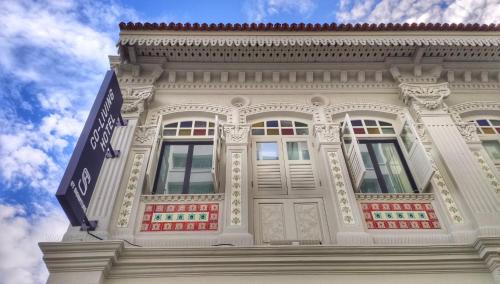 a white building with a street sign in front of it at ST Signature Jalan Besar, SHORT OVERNIGHT, 8 Hours, 1159PM-8AM in Singapore