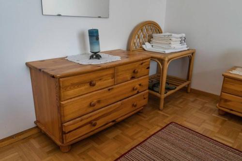 a wooden dresser with a lamp on top of it at APARTMA JANŠA in Bled