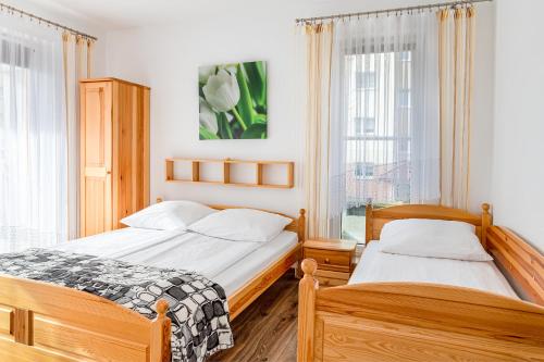 1 dormitorio con 2 camas y ventana en Family Homes - Apartamenty Sonoma, en Władysławowo