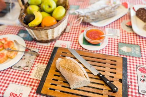 a cutting board with a piece of bread on a table at Hotel Ancora in Palamós