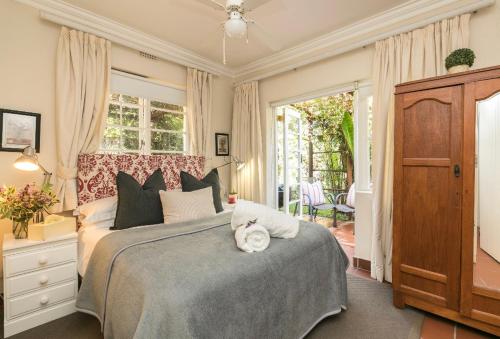 a bedroom with a large bed and a window at Waterfall Cottages in Johannesburg