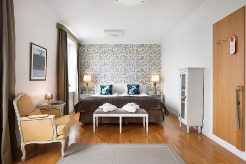 a bedroom with a bed and a table at Lejondals Slott in Bro