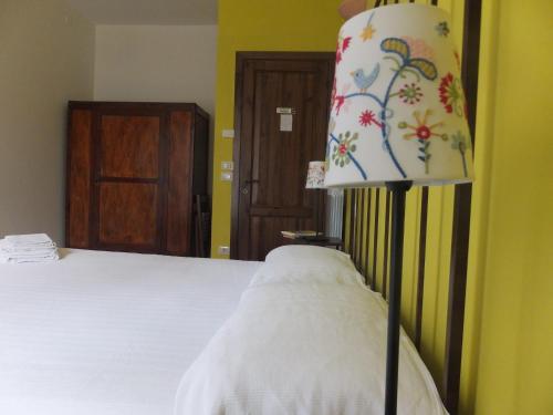 a bedroom with a bed with a lamp next to it at Cascina Antonini in Foligno