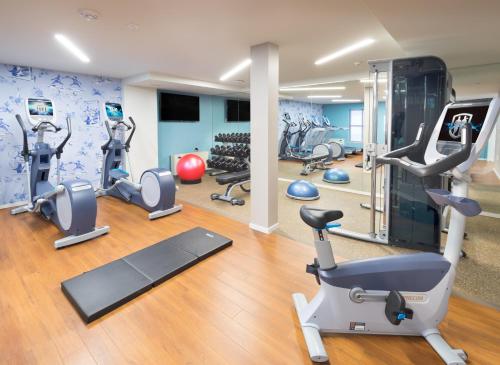 a gym with treadmills and exercise equipment in a room at Hotel Indigo Old Town Alexandria by IHG in Alexandria