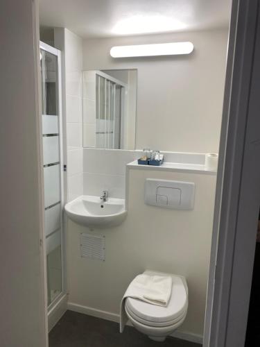 a white bathroom with a sink and a toilet at Fast Hotel Brie-Comte-Robert in Brie-Comte-Robert