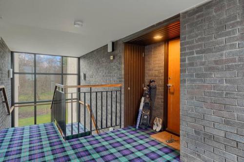 a room with a staircase and a stair case at 45 Guthrie Court, Fantastic top floor apartment next to Gleneagles in Auchterarder