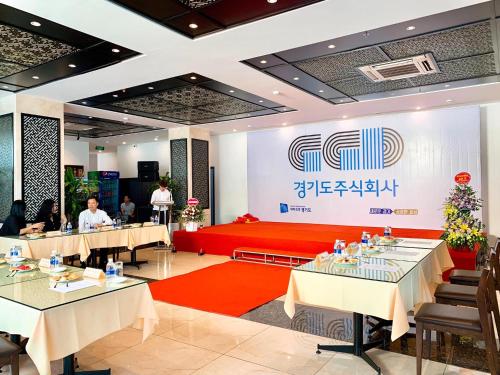 a meeting room with tables and a sign on the wall at Friendship hotel in Hanoi