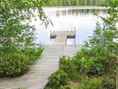 a wooden dock on a lake with a dock at Holiday Home Kallionnenä by Interhome in Mäkikylä