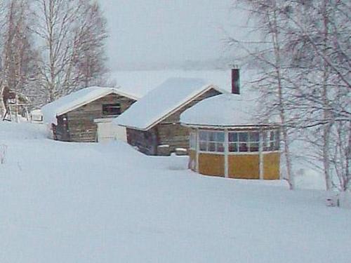 una casa cubierta de nieve delante en Holiday Home Raanumökki 1 by Interhome, en Lampsijärvi