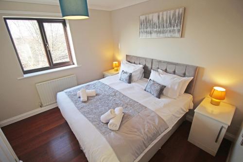 a bedroom with a bed with two towels on it at The Barwoods - Modern Spacious Home in Chester - Parking in Chester