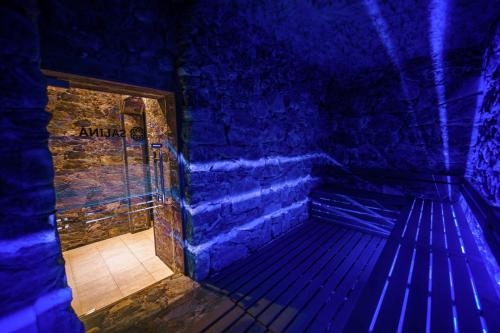 a room with a bench in a room with blue lights at Hotel Piatra Mare in Poiana Brasov