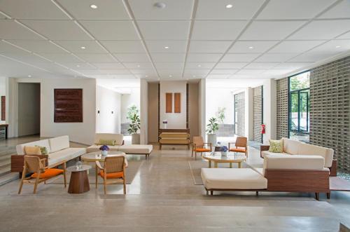 a lobby with couches and chairs and tables at Hanoman Hotel Kota Batu in Batu