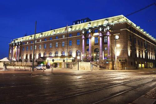 a large building with a clock on the side of it at Clarion Hotel Post in Gothenburg