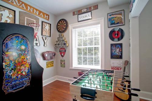 a room with a wall filled with lots of decorations at Newly Renovated 4 bed 3 bath and 2 Parking Spots in Savannah
