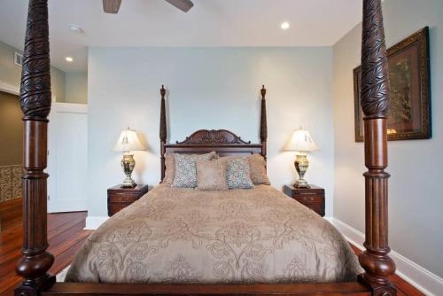 a bedroom with a large bed with two lamps at Newly Renovated 4 bed 3 bath and 2 Parking Spots in Savannah