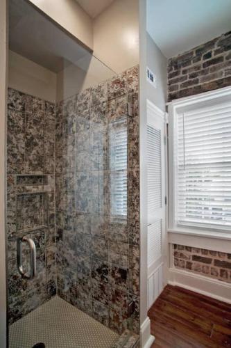 a bathroom with a walk in shower next to a window at Newly Renovated 4 bed 3 bath and 2 Parking Spots in Savannah