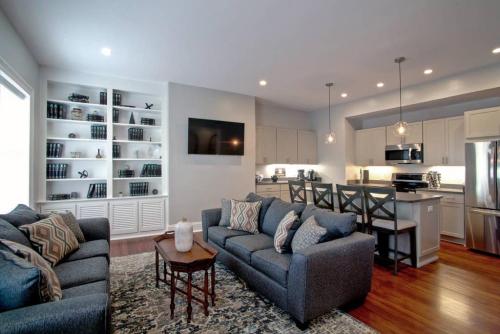 a living room with a couch and a kitchen at Newly Renovated 4 bed 3 bath and 2 Parking Spots in Savannah