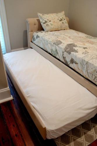 a bed in a room with a white mattress at Restored Historic Home 5 bedroom 4 and a Half Bath in Savannah