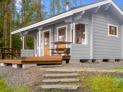 une petite maison avec une terrasse couverte et une terrasse en bois dans l'établissement Holiday Home Hukka 7 by Interhome, à Harkala