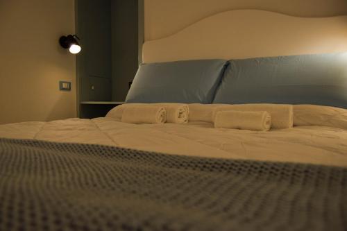 a bed with two white towels on top of it at Leavì in Polignano a Mare