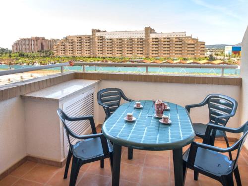 a blue table and chairs on a balcony at Apartment La Mar Bella by Interhome in El Borseral