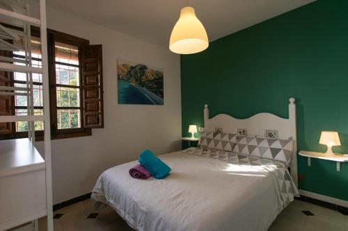 Postel nebo postele na pokoji v ubytování CASA CUARTEL EL VELERO