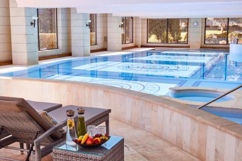 a large swimming pool in a hotel with a bowl of fruit at Steigenberger Hotel and Resort Camp de Mar in Camp de Mar