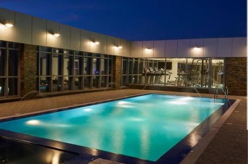 a swimming pool in the middle of a building at night at AlHamra Hotel Kuwait in Kuwait