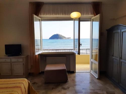 a bedroom with a window with a view of the ocean at Residence Sole in Albenga