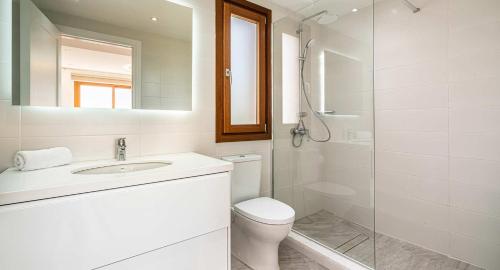 a bathroom with a toilet and a sink and a shower at 4 bedroom Villa Helidoni with private infinity pool, Aphrodite Hills Resort in Kouklia