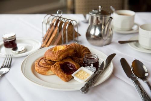 a white plate with pastries on a table at Keswick Country House Hotel in Keswick