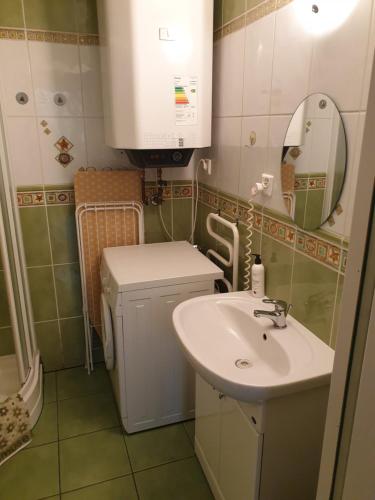 a small bathroom with a sink and a mirror at Domek Epona in Szklarska Poręba