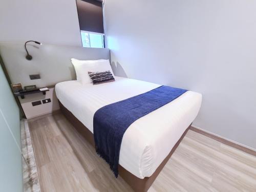 Ένα ή περισσότερα κρεβάτια σε δωμάτιο στο SOVA Hotel Bangkok
