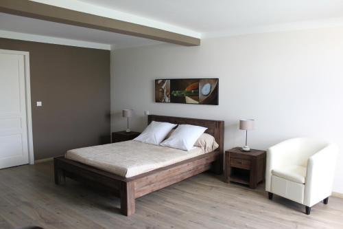 a bedroom with a bed and a couch and a chair at E Cabanacce in Aléria