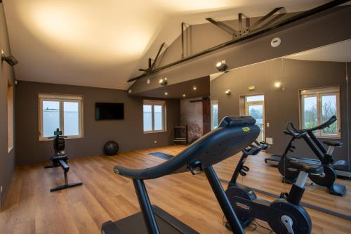 a gym with two exercise bikes in a room at L'Orée du Bois in Vittel