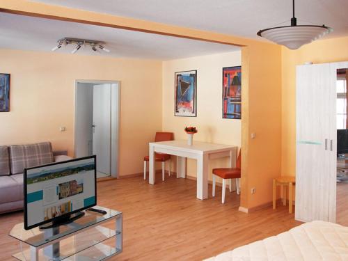 a living room with a couch and a table with a television at Ferienwohnung Bernhardt in Zella-Mehlis
