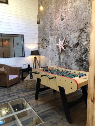a living room with a foosball table at le 25bis in Saint-Martory