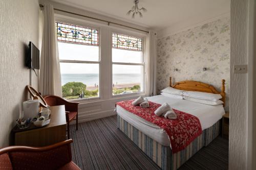 a hotel room with a bed and a window at Somerset Hotel in Llandudno