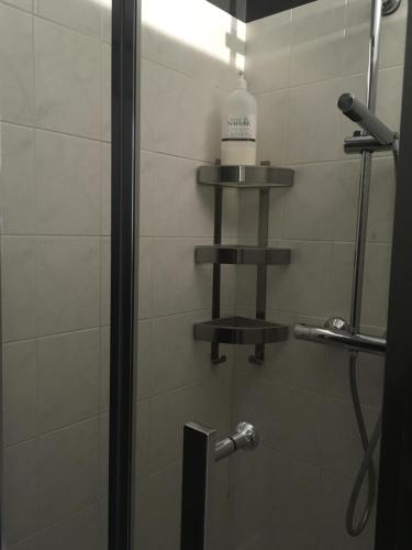 a bathroom with a shower with a bottle on the wall at Le Soleil Do' Ré in Sainte-Marie-de-Ré