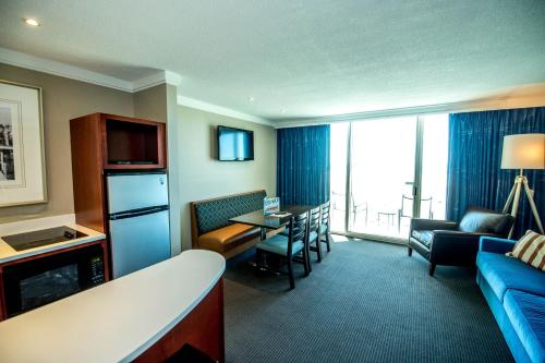 a hotel room with a kitchen and a living room at Port Royal Oceanfront Hotel in Wildwood Crest