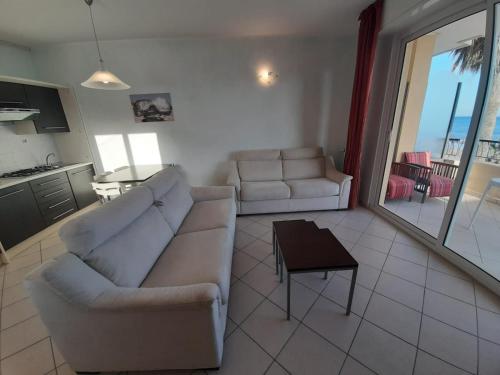 a living room with a couch and a table at Residence Sole in Albenga