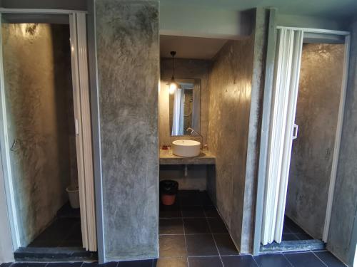 a bathroom with a sink and a mirror at 8 SLEEPER STREET Guesthouse in Krabi town
